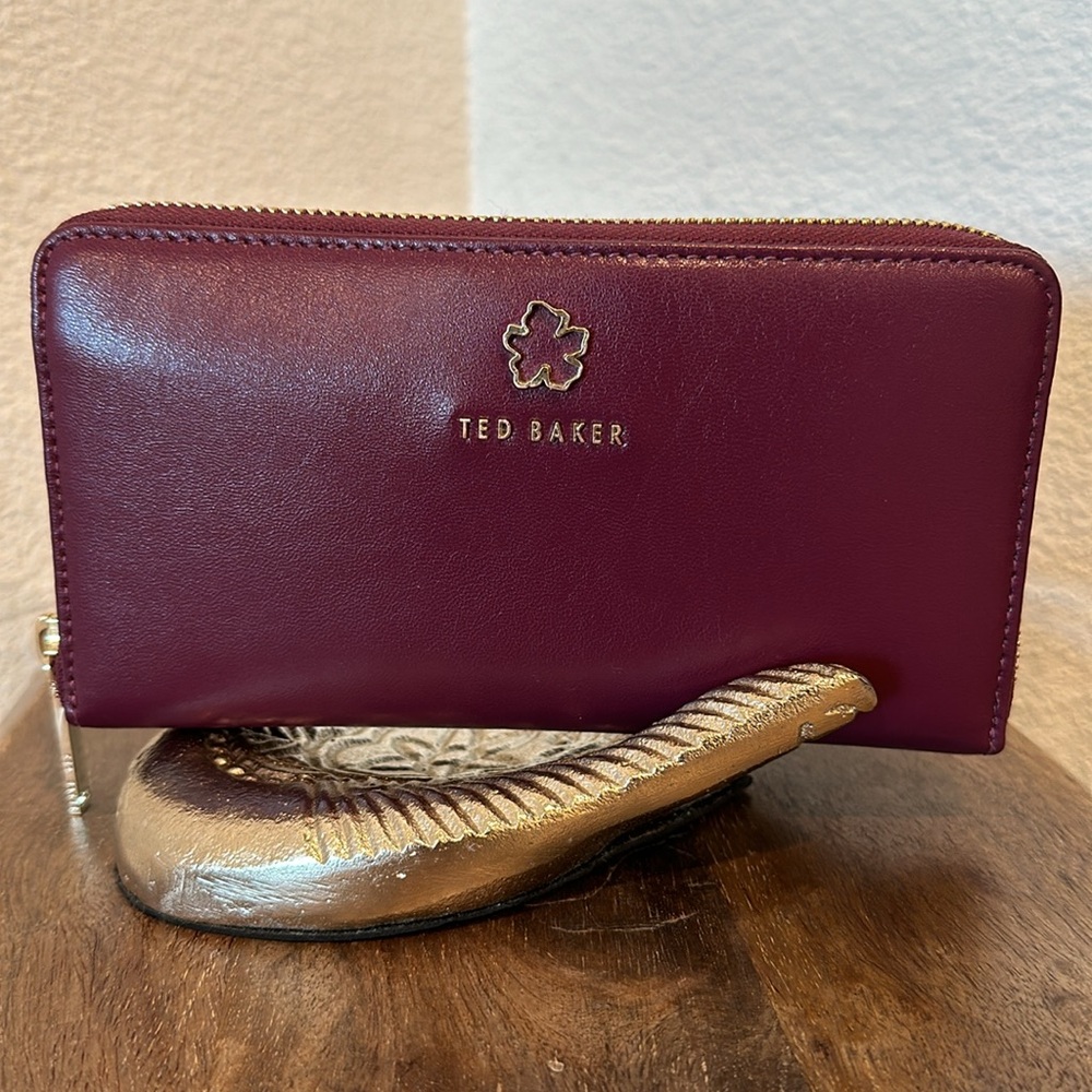 TED BAKER JORJANA LEATHER FLOWER EYELET ZIP AROUND WALLET IN OXBLOOD